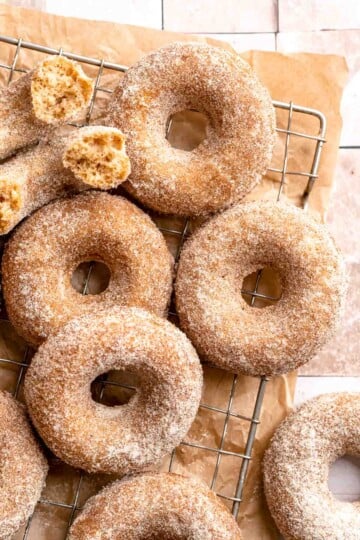 Indulge in the flavors of fall with these delicious baked apple cider donuts coated in spiced cinnamon sugar. An easy to make and cozy fall treat! | aheadofthyme.com