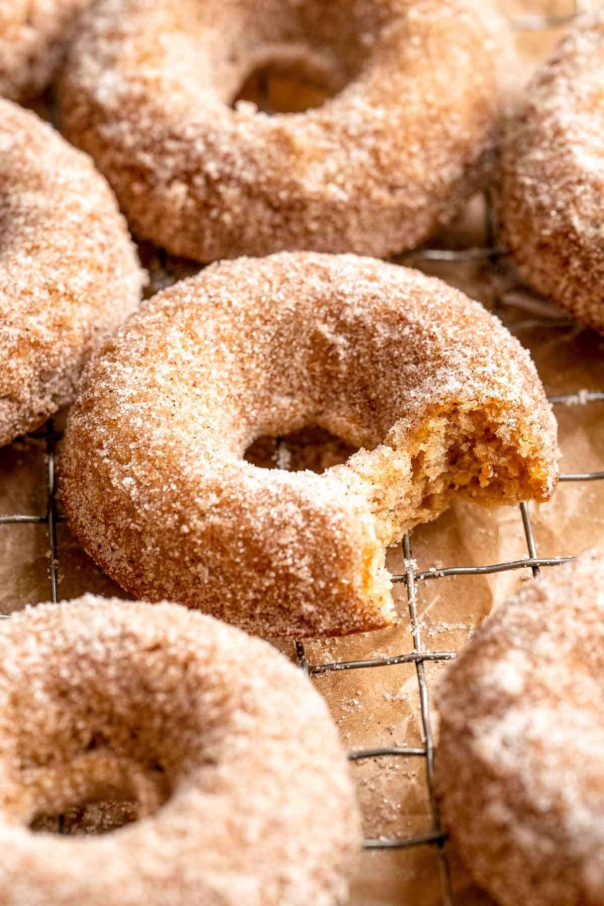 Indulge in the flavors of fall with these delicious baked apple cider donuts coated in spiced cinnamon sugar. An easy to make and cozy fall treat! | aheadofthyme.com