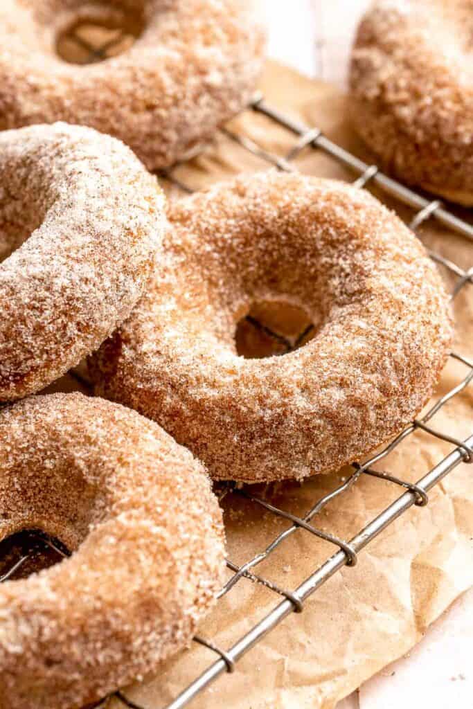 Indulge in the flavors of fall with these delicious baked apple cider donuts coated in spiced cinnamon sugar. An easy to make and cozy fall treat! | aheadofthyme.com