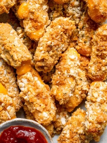 These delicious baked cheddar cheese sticks are the best snack or appetizer: crispy on the outside and gooey on the inside. Perfect for cheese lovers! | aheadofthyme.com