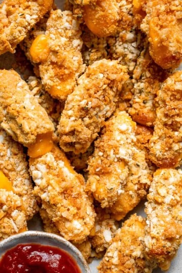 These delicious baked cheddar cheese sticks are the best snack or appetizer: crispy on the outside and gooey on the inside. Perfect for cheese lovers! | aheadofthyme.com