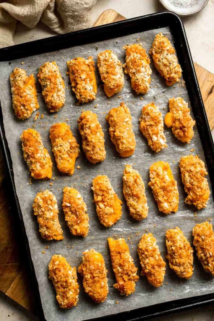 These delicious baked cheddar cheese sticks are the best snack or appetizer: crispy on the outside and gooey on the inside. Perfect for cheese lovers! | aheadofthyme.com