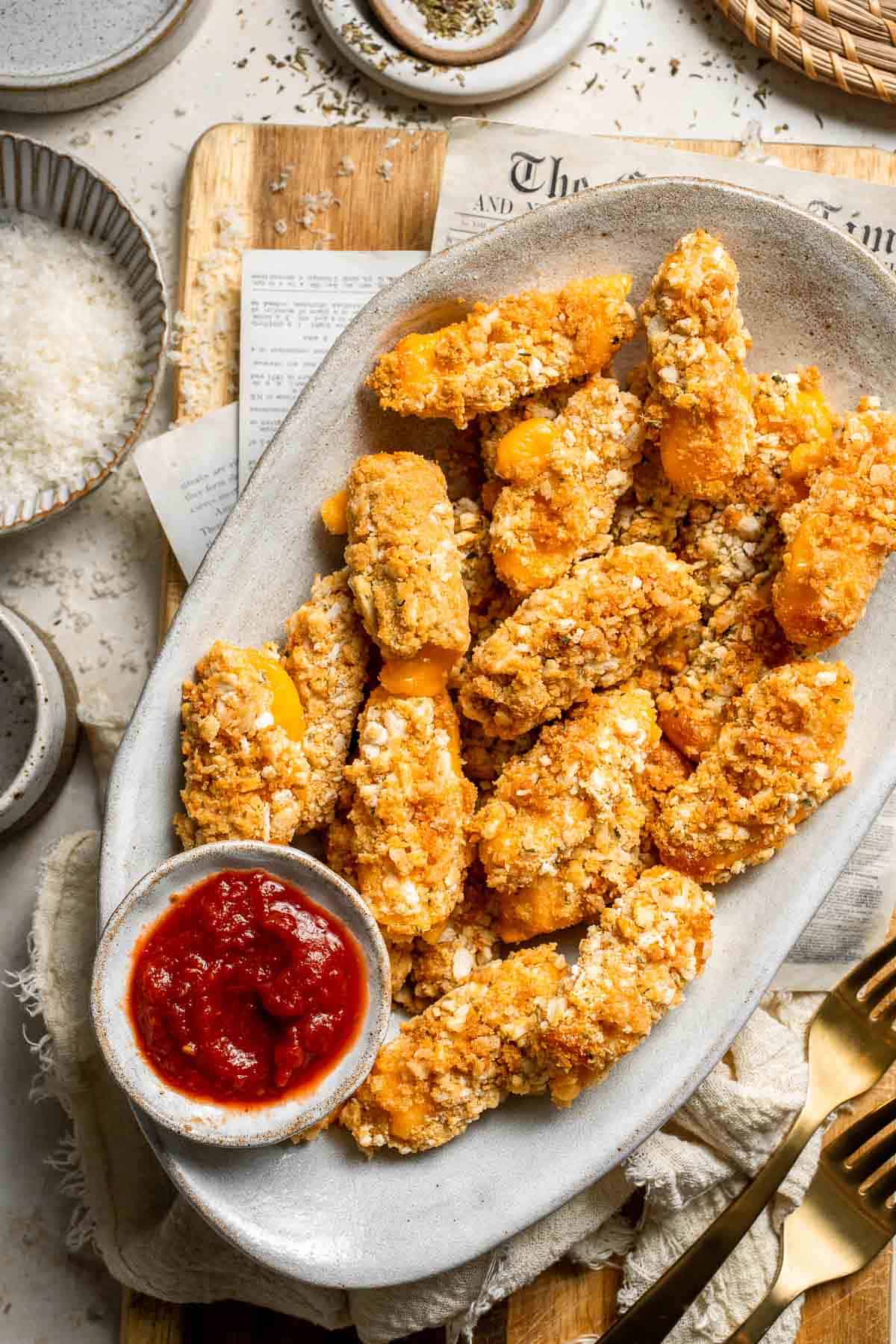 These delicious baked cheddar cheese sticks are the best snack or appetizer: crispy on the outside and gooey on the inside. Perfect for cheese lovers! | aheadofthyme.com