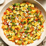 Calabacitas (Mexican Zucchini) is a traditional side dish made with zucchini, corn, tomatoes, and peppers. Make these colorful veggies in just 20 minutes. | aheadofthyme.com