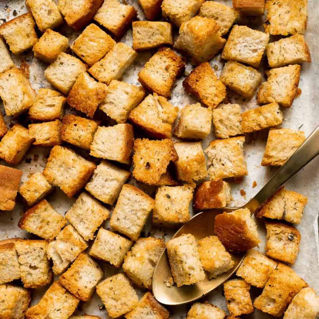 Looking for a simple and delicious way to use up leftover bread? Try this easy homemade croutons recipe that will elevate any salad or soup. | aheadofthyme.com