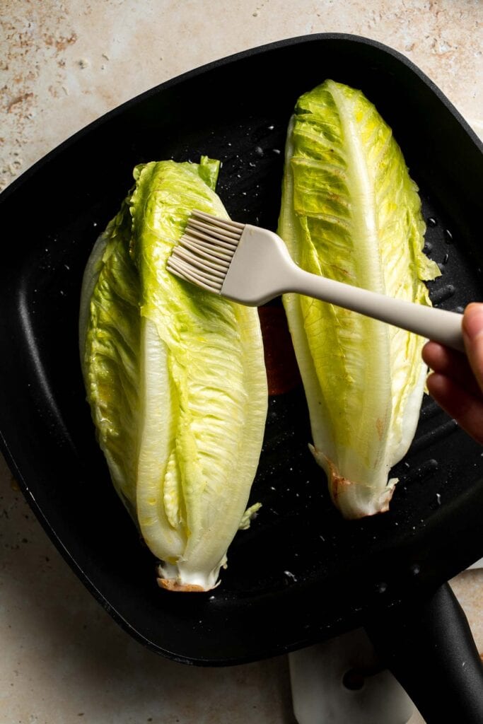 Elevate your salad game with this grilled romaine Caesar salad and homemade dressing. The smoky flavor from grilling the lettuce adds a unique twist. | aheadofthyme.com