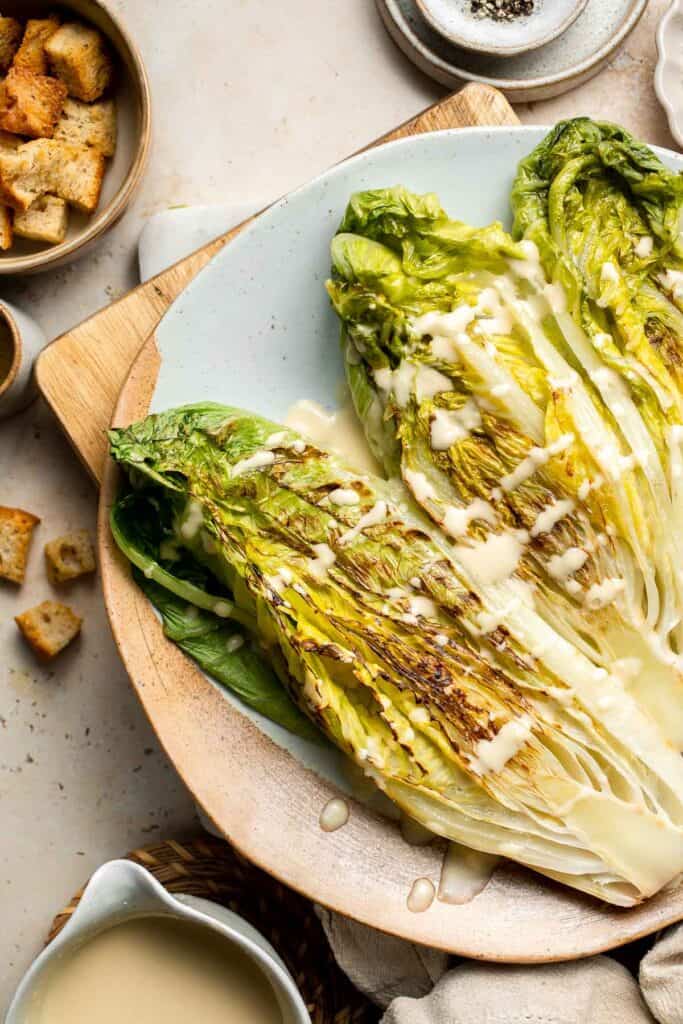 Elevate your salad game with this grilled romaine Caesar salad and homemade dressing. The smoky flavor from grilling the lettuce adds a unique twist. | aheadofthyme.com