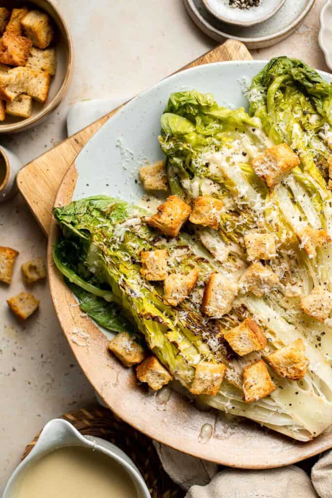 Elevate your salad game with this grilled romaine Caesar salad and homemade dressing. The smoky flavor from grilling the lettuce adds a unique twist. | aheadofthyme.com