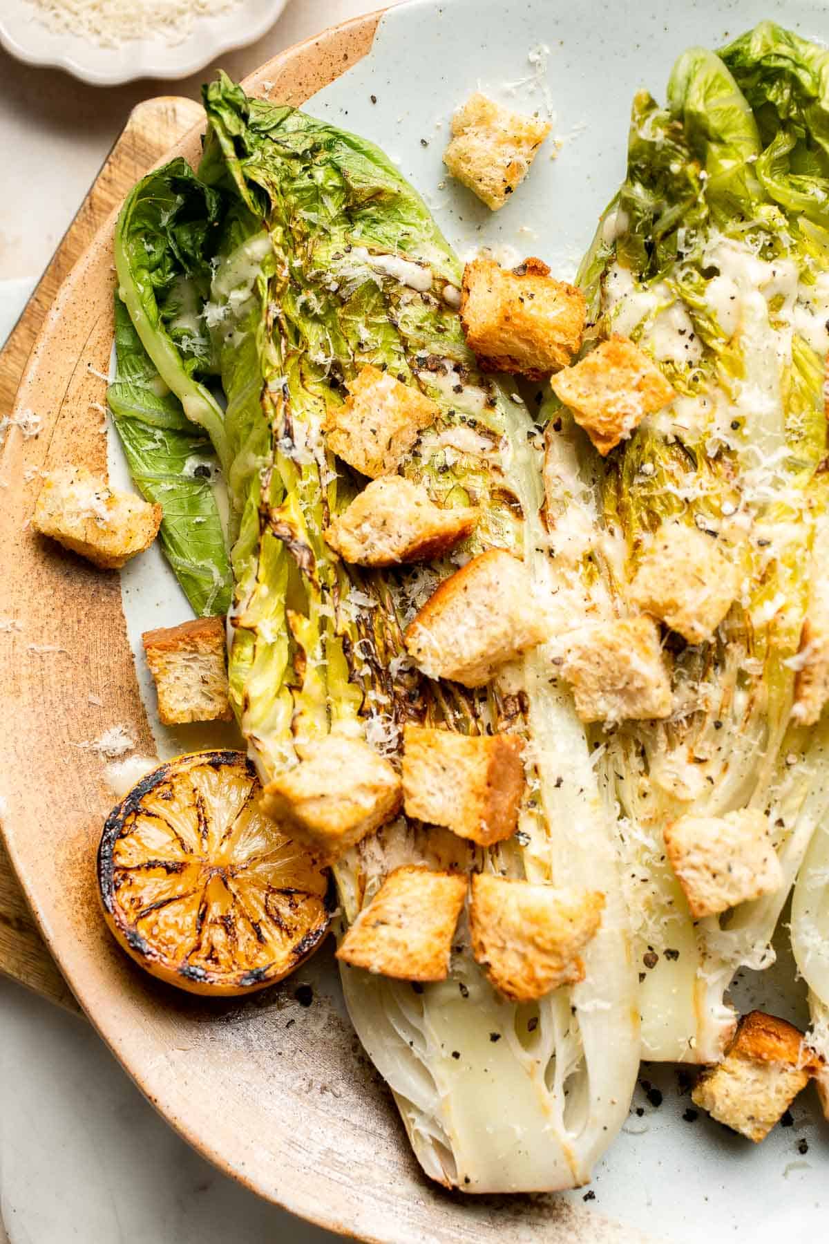 Elevate your salad game with this grilled romaine Caesar salad and homemade dressing. The smoky flavor from grilling the lettuce adds a unique twist. | aheadofthyme.com
