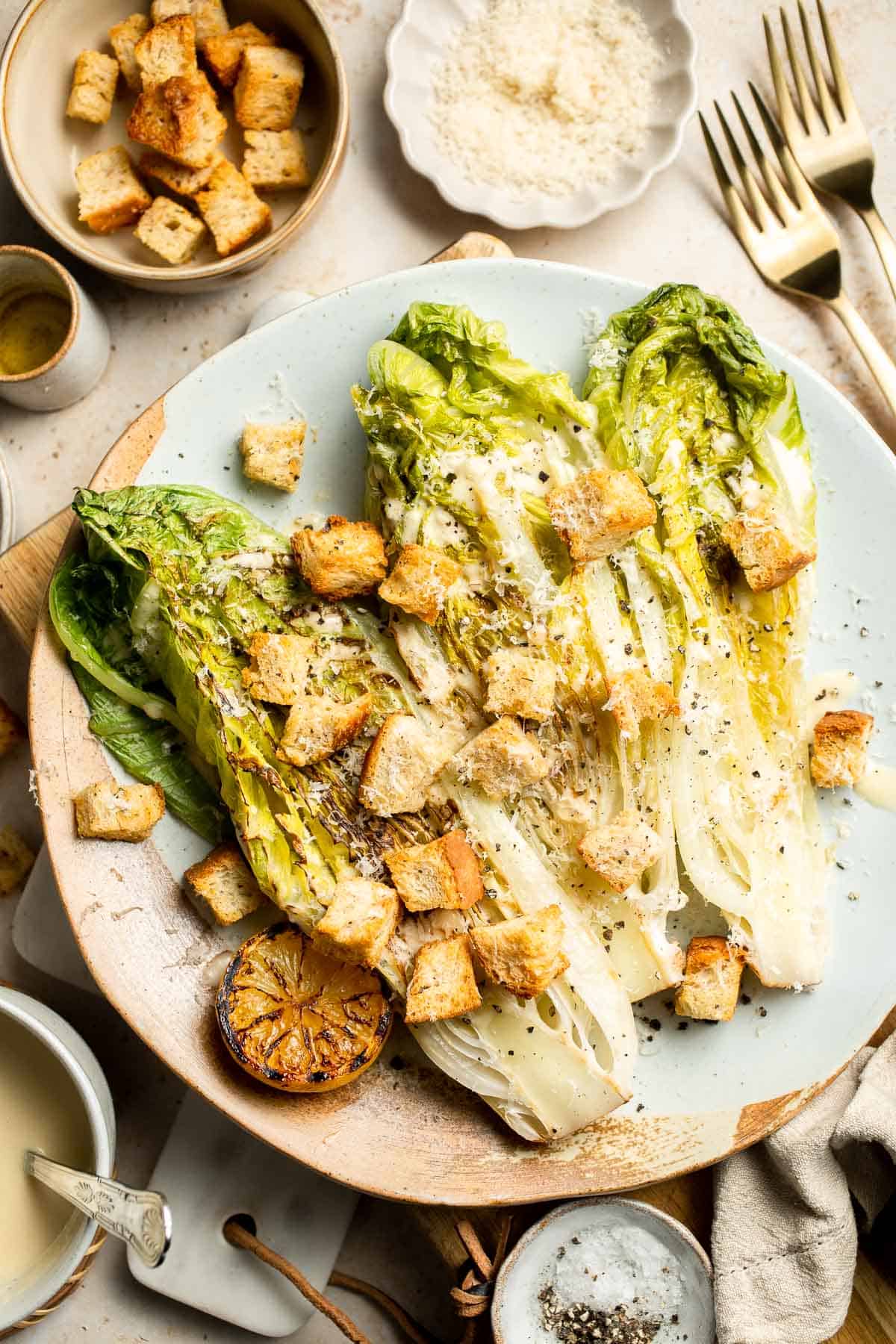 Elevate your salad game with this grilled romaine Caesar salad and homemade dressing. The smoky flavor from grilling the lettuce adds a unique twist. | aheadofthyme.com