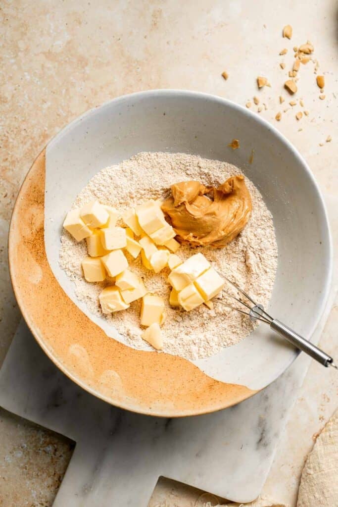 Delicious, protein-packed peanut butter muffins with a crunchy streusel topping are perfect for breakfast or as a midday snack. Soft, fluffy, and tasty! | aheadofthyme.com