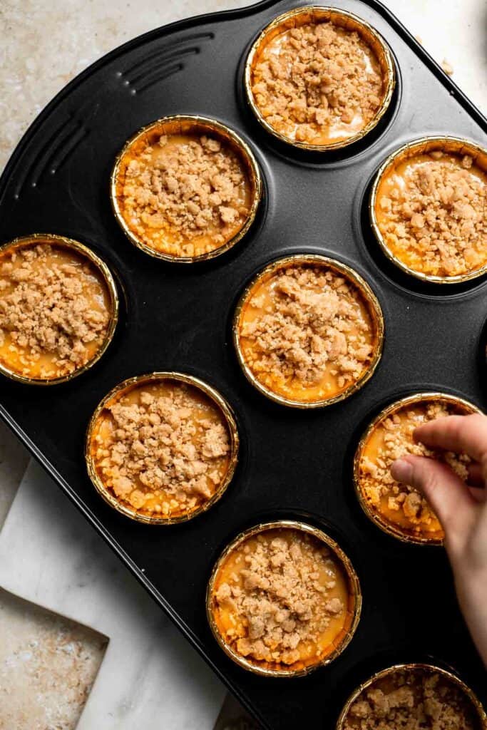 Delicious, protein-packed peanut butter muffins with a crunchy streusel topping are perfect for breakfast or as a midday snack. Soft, fluffy, and tasty! | aheadofthyme.com