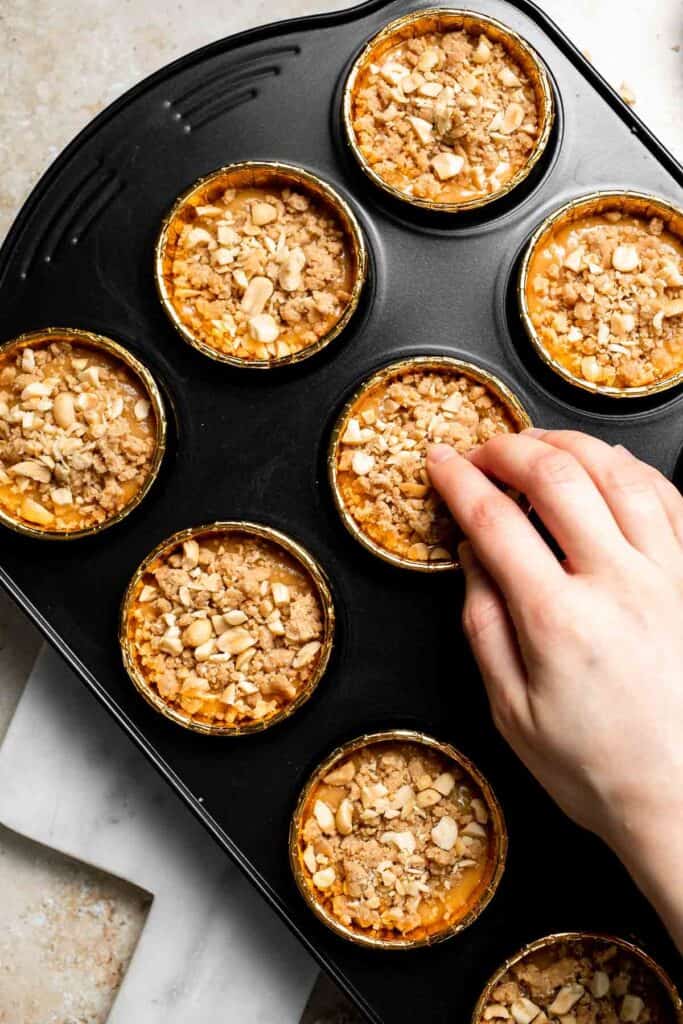 Delicious, protein-packed peanut butter muffins with a crunchy streusel topping are perfect for breakfast or as a midday snack. Soft, fluffy, and tasty! | aheadofthyme.com