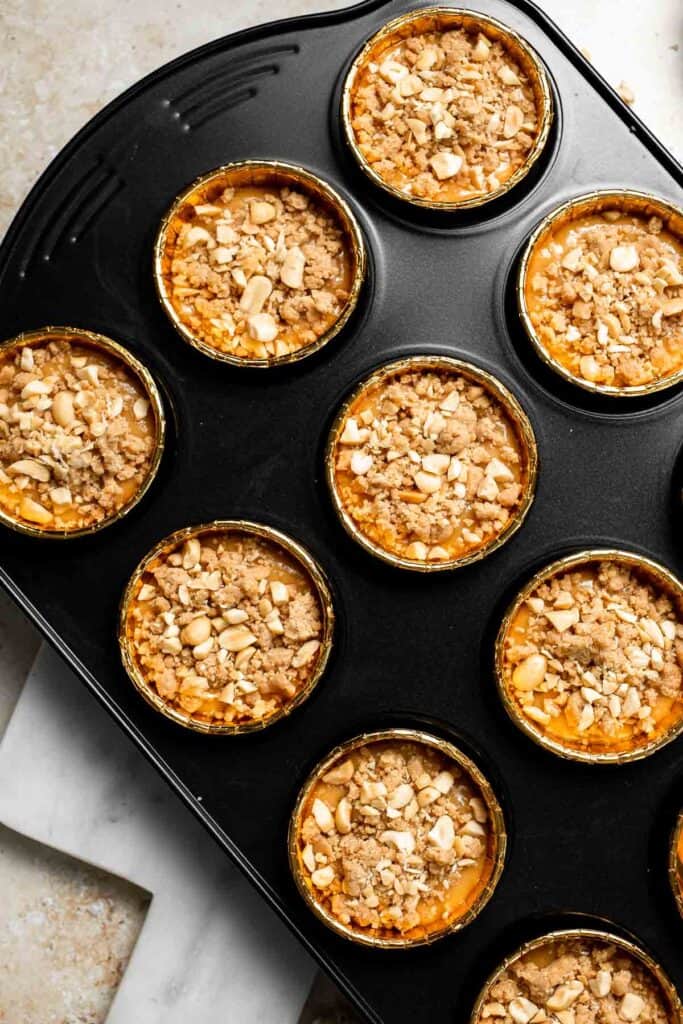 Delicious, protein-packed peanut butter muffins with a crunchy streusel topping are perfect for breakfast or as a midday snack. Soft, fluffy, and tasty! | aheadofthyme.com