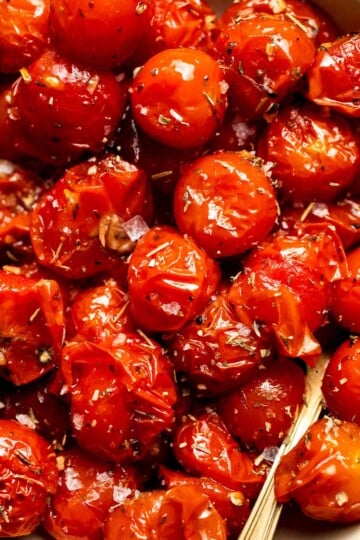 Easy to make and bursting with flavor, these juicy Roasted Cherry Tomatoes with garlic, herbs, and balsamic are the perfect addition to any meal. | aheadofthyme.com