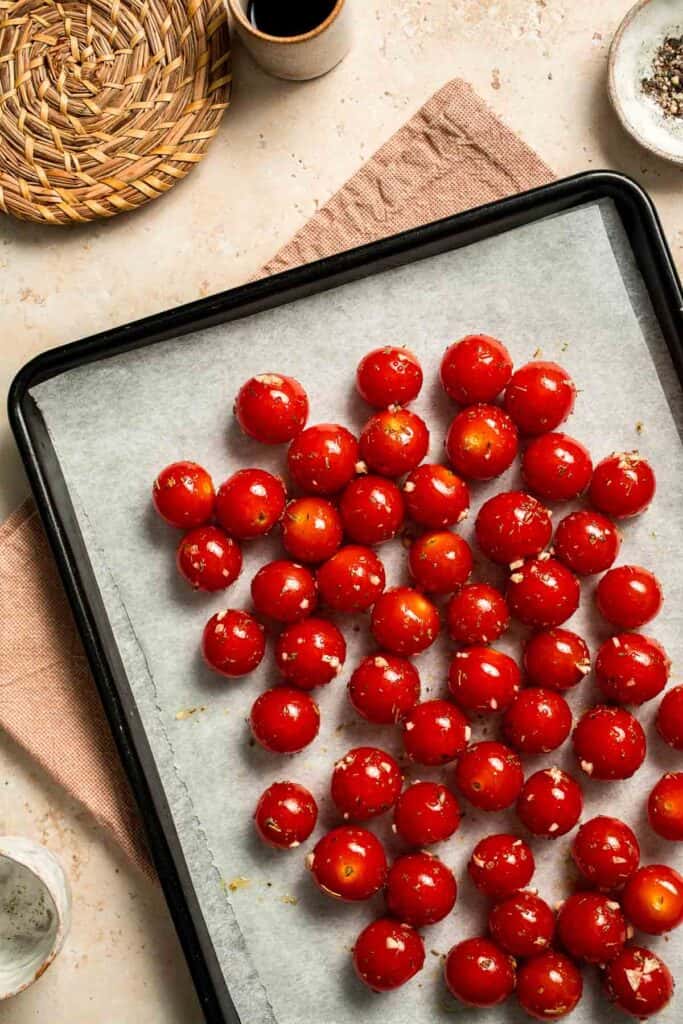 Easy to make and bursting with flavor, these juicy Roasted Cherry Tomatoes with garlic, herbs, and balsamic are the perfect addition to any meal. | aheadofthyme.com