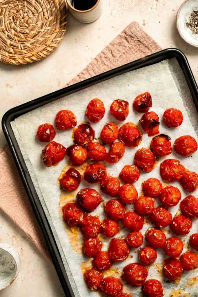 Easy to make and bursting with flavor, these juicy Roasted Cherry Tomatoes with garlic, herbs, and balsamic are the perfect addition to any meal. | aheadofthyme.com