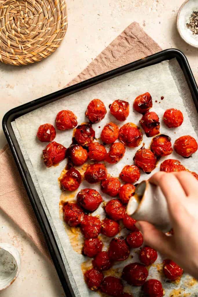 Easy to make and bursting with flavor, these juicy Roasted Cherry Tomatoes with garlic, herbs, and balsamic are the perfect addition to any meal. | aheadofthyme.com