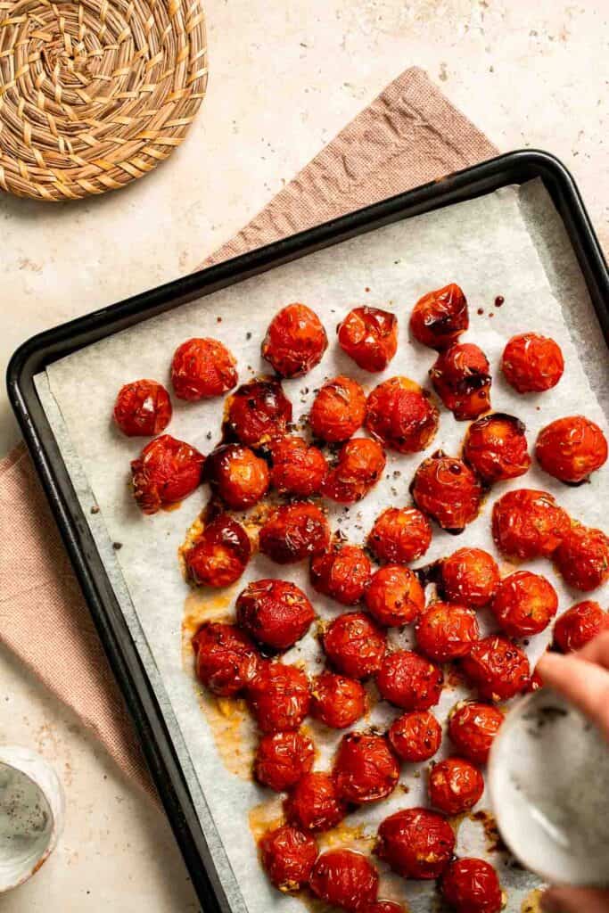 Easy to make and bursting with flavor, these juicy Roasted Cherry Tomatoes with garlic, herbs, and balsamic are the perfect addition to any meal. | aheadofthyme.com