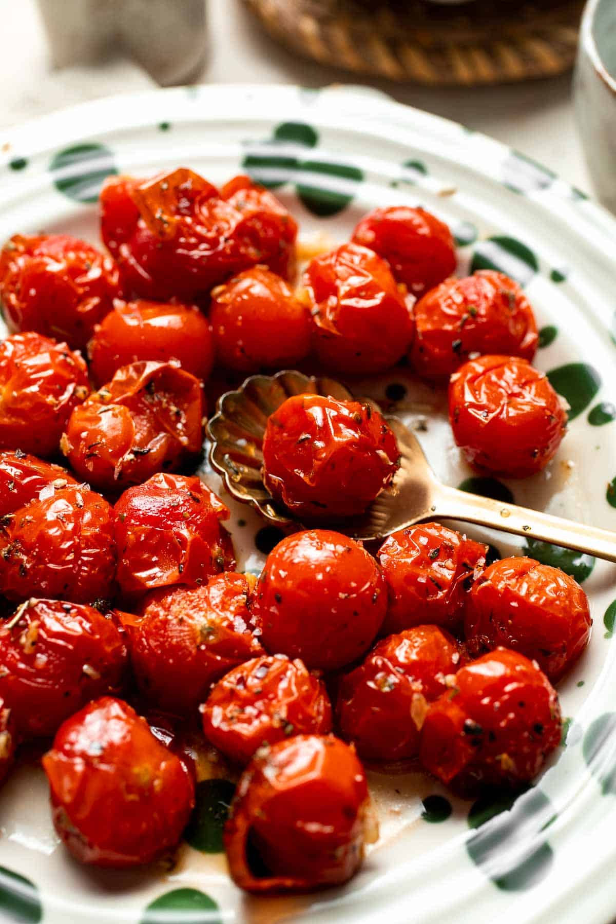 Easy to make and bursting with flavor, these juicy Roasted Cherry Tomatoes with garlic, herbs, and balsamic are the perfect addition to any meal. | aheadofthyme.com