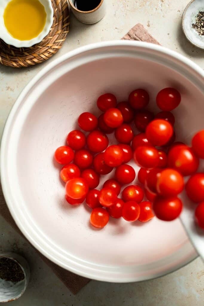Easy to make and bursting with flavor, these juicy Roasted Cherry Tomatoes with garlic, herbs, and balsamic are the perfect addition to any meal. | aheadofthyme.com