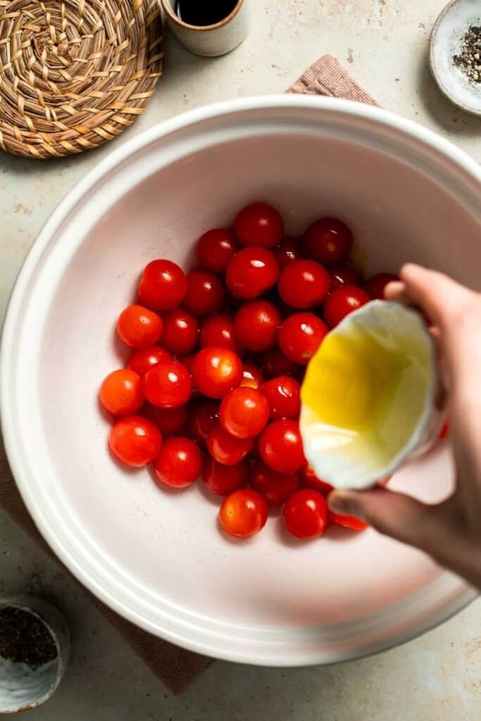 Easy to make and bursting with flavor, these juicy Roasted Cherry Tomatoes with garlic, herbs, and balsamic are the perfect addition to any meal. | aheadofthyme.com