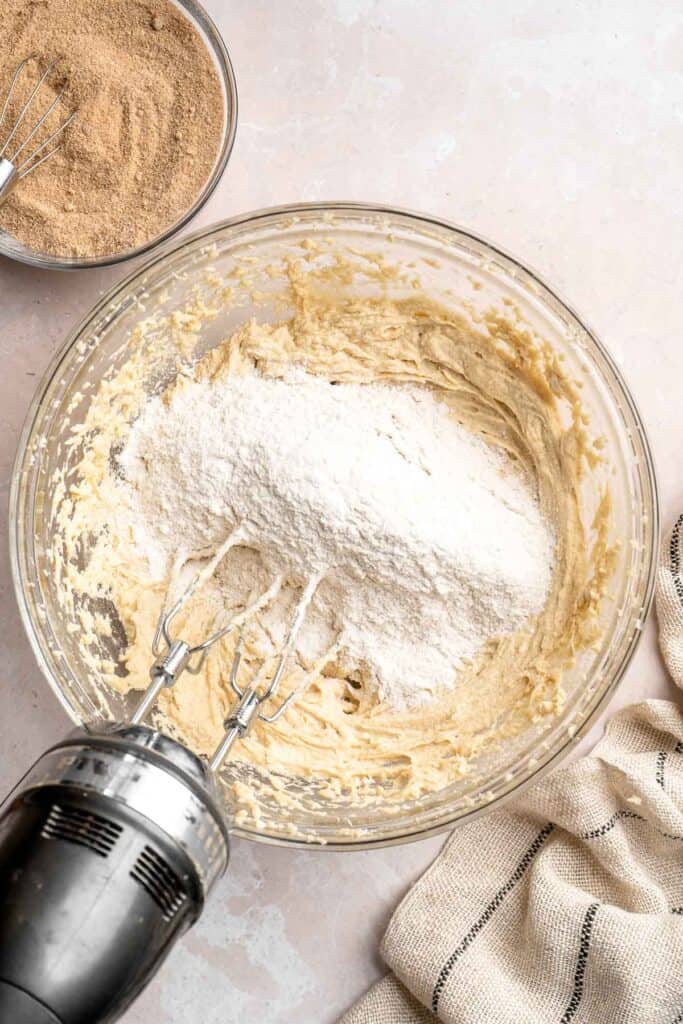 This sour cream coffee cake with cinnamon swirl is soft, buttery, and topped with crunchy streusel and vanilla glaze. Perfect for brunch or dessert. | aheadofthyme.com