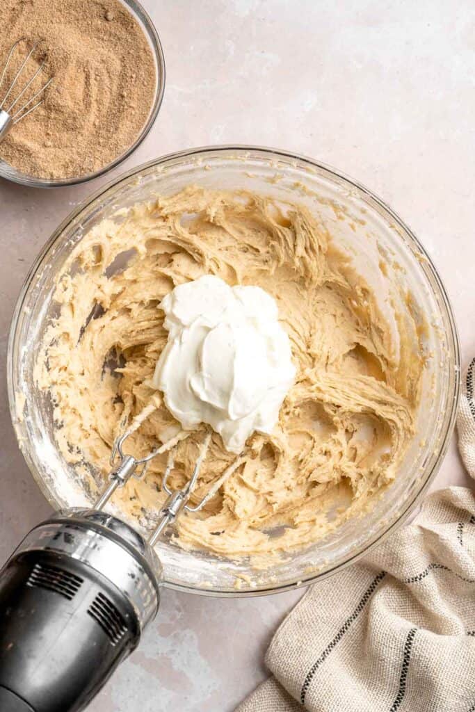 This sour cream coffee cake with cinnamon swirl is soft, buttery, and topped with crunchy streusel and vanilla glaze. Perfect for brunch or dessert. | aheadofthyme.com