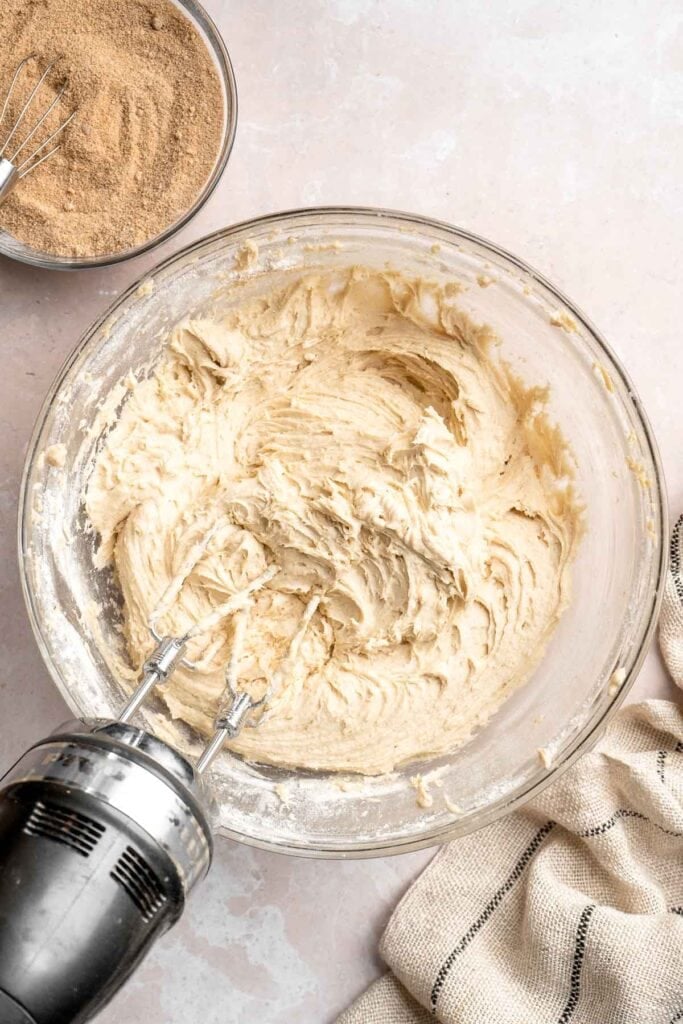 This sour cream coffee cake with cinnamon swirl is soft, buttery, and topped with crunchy streusel and vanilla glaze. Perfect for brunch or dessert. | aheadofthyme.com
