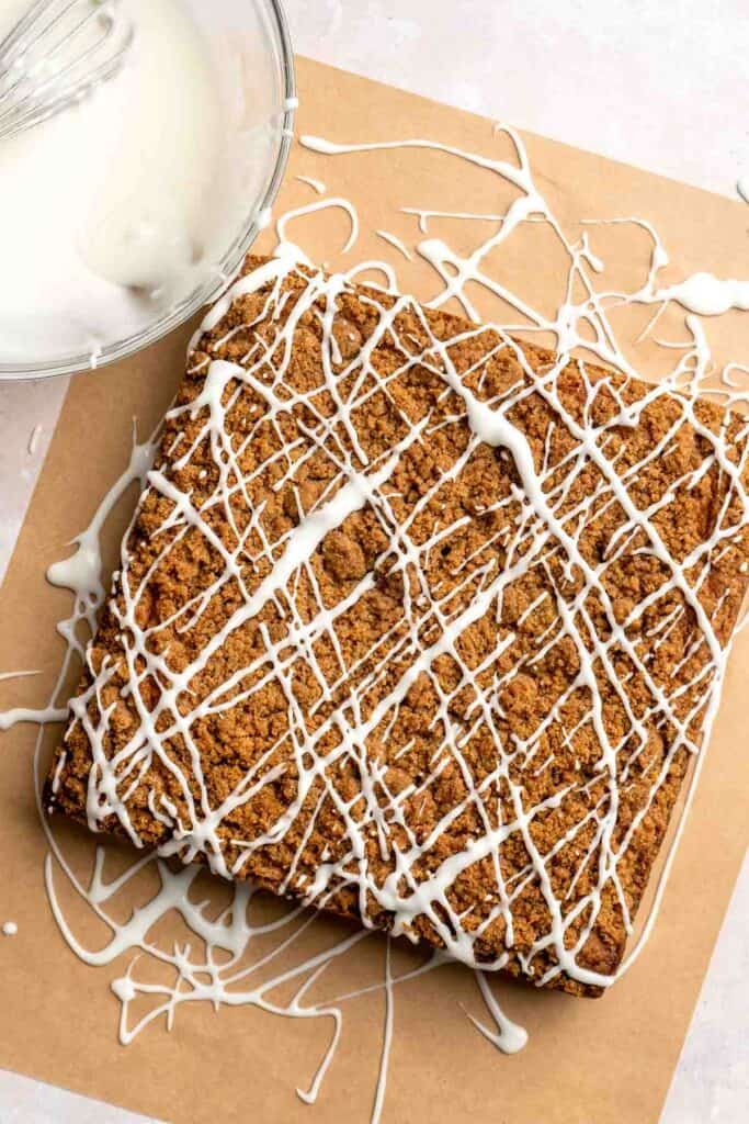 This sour cream coffee cake with cinnamon swirl is soft, buttery, and topped with crunchy streusel and vanilla glaze. Perfect for brunch or dessert. | aheadofthyme.com