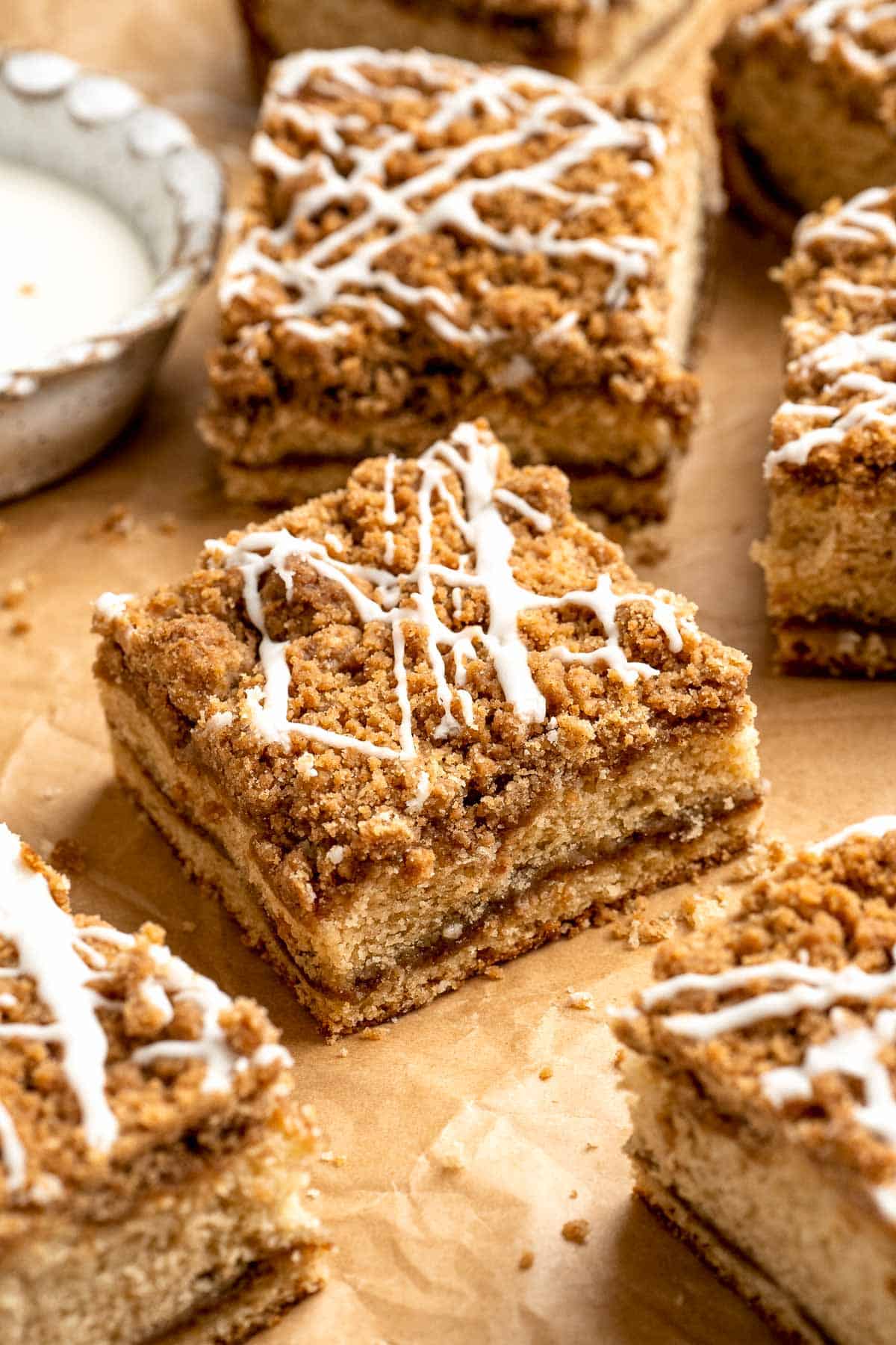 This sour cream coffee cake with cinnamon swirl is soft, buttery, and topped with crunchy streusel and vanilla glaze. Perfect for brunch or dessert. | aheadofthyme.com
