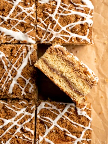 This sour cream coffee cake with cinnamon swirl is soft, buttery, and topped with crunchy streusel and vanilla glaze. Perfect for brunch or dessert. | aheadofthyme.com