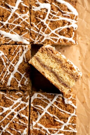 This sour cream coffee cake with cinnamon swirl is soft, buttery, and topped with crunchy streusel and vanilla glaze. Perfect for brunch or dessert. | aheadofthyme.com