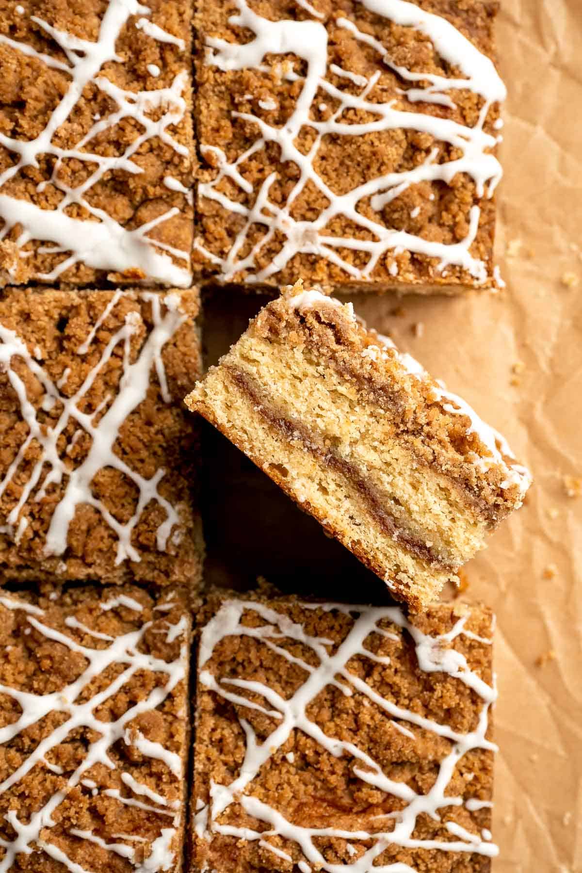 This sour cream coffee cake with cinnamon swirl is soft, buttery, and topped with crunchy streusel and vanilla glaze. Perfect for brunch or dessert. | aheadofthyme.com
