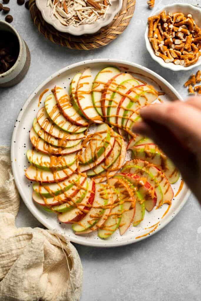 Apple Nachos are a quick, healthy snack made with crisp apples, nut butter, and toppings. Fun, customizable, and ready in minutes! | aheadofthyme.com