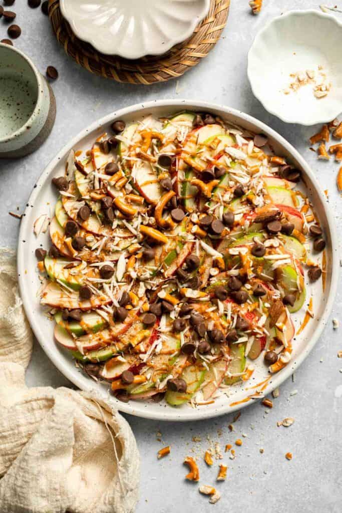 Apple Nachos are a quick, healthy snack made with crisp apples, nut butter, and toppings. Fun, customizable, and ready in minutes! | aheadofthyme.com