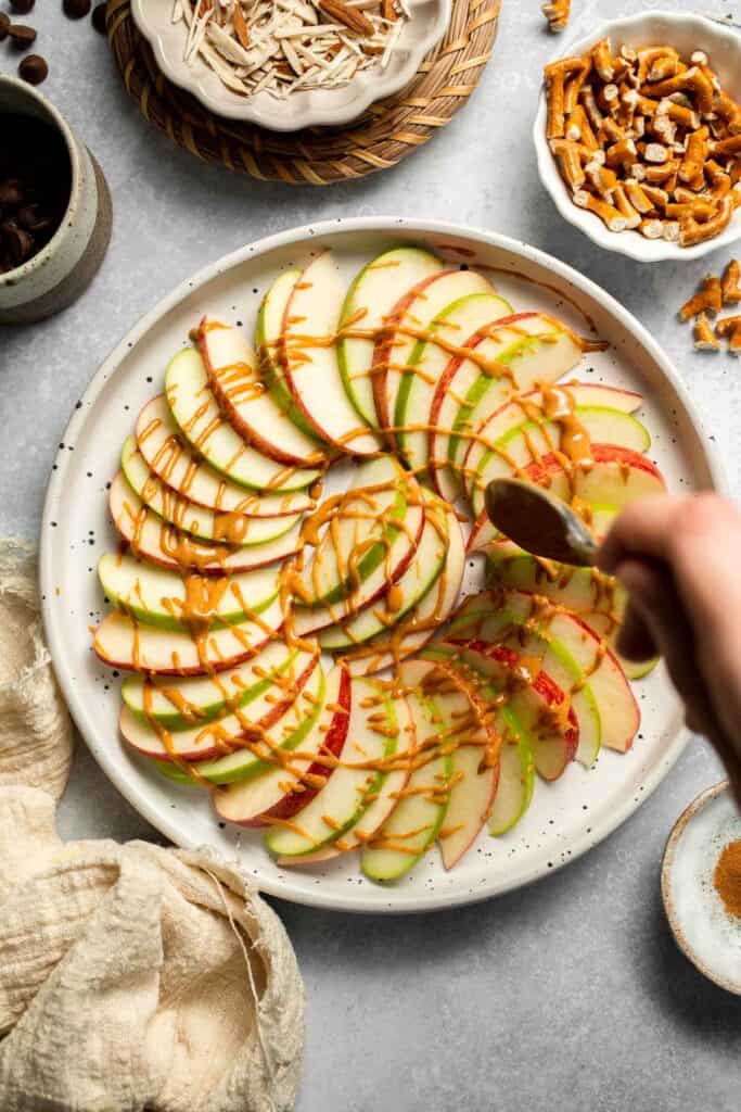 Apple Nachos are a quick, healthy snack made with crisp apples, nut butter, and toppings. Fun, customizable, and ready in minutes! | aheadofthyme.com