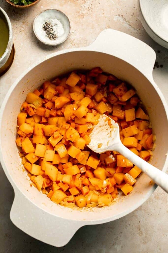 Enjoy a cozy bowl of butternut squash lentil soup, packed with protein, fiber, and nutrients. This hearty recipe makes the ultimate plant-based meal. | aheadofthyme.com