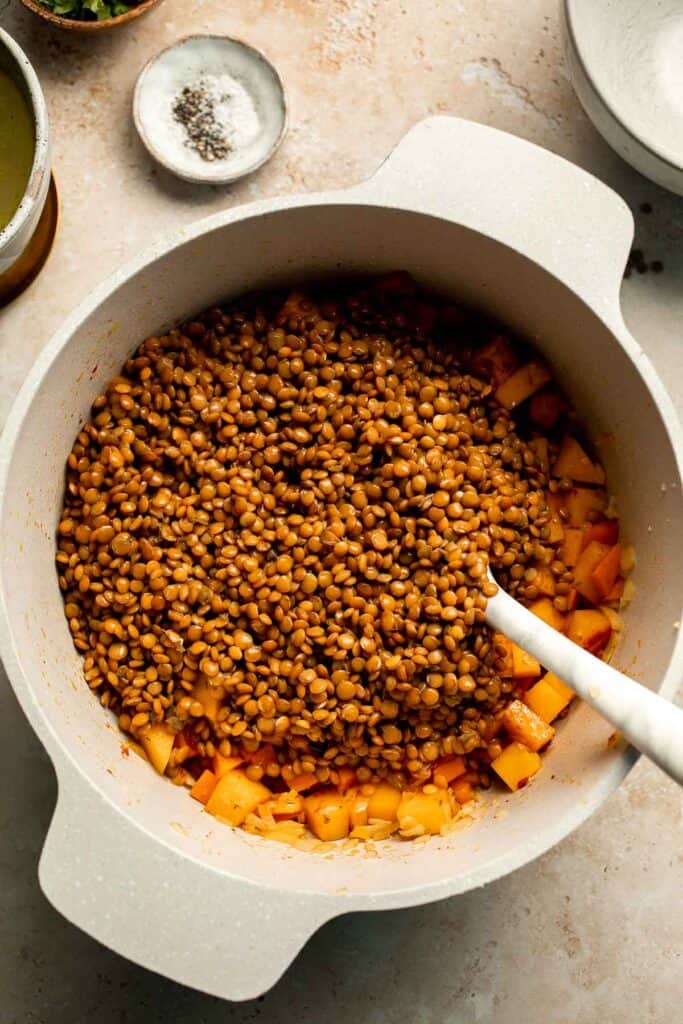 Enjoy a cozy bowl of butternut squash lentil soup, packed with protein, fiber, and nutrients. This hearty recipe makes the ultimate plant-based meal. | aheadofthyme.com