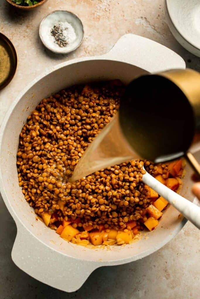 Enjoy a cozy bowl of butternut squash lentil soup, packed with protein, fiber, and nutrients. This hearty recipe makes the ultimate plant-based meal. | aheadofthyme.com