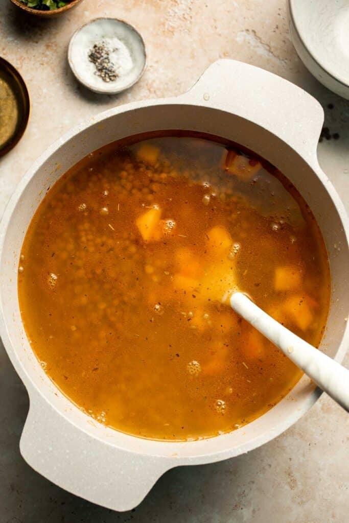 Enjoy a cozy bowl of butternut squash lentil soup, packed with protein, fiber, and nutrients. This hearty recipe makes the ultimate plant-based meal. | aheadofthyme.com