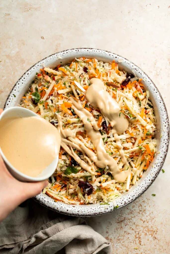 This easy apple slaw recipe is the perfect combination of crisp apples, crunchy cabbage, and a creamy dressing. A fresh side dish ready in 10 minutes! | aheadofthyme.com