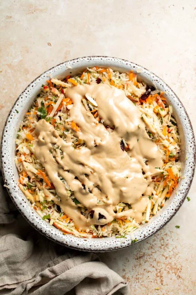 This easy apple slaw recipe is the perfect combination of crisp apples, crunchy cabbage, and a creamy dressing. A fresh side dish ready in 10 minutes! | aheadofthyme.com