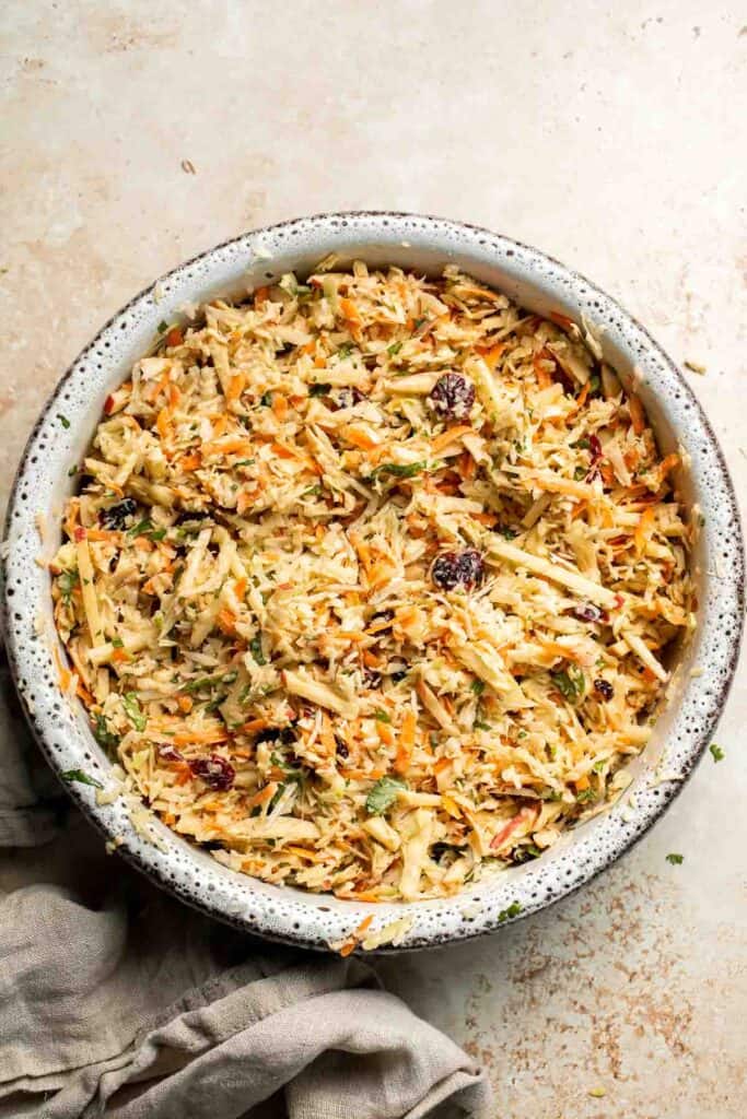 This easy apple slaw recipe is the perfect combination of crisp apples, crunchy cabbage, and a creamy dressing. A fresh side dish ready in 10 minutes! | aheadofthyme.com