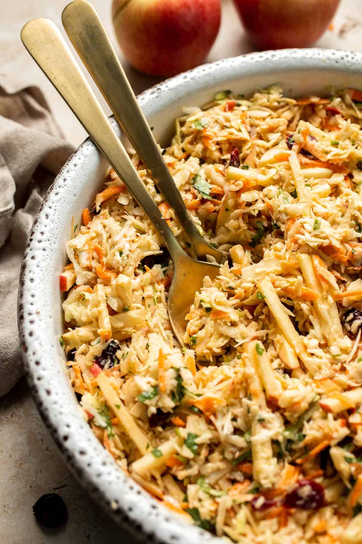 This easy apple slaw recipe is the perfect combination of crisp apples, crunchy cabbage, and a creamy dressing. A fresh side dish ready in 10 minutes! | aheadofthyme.com