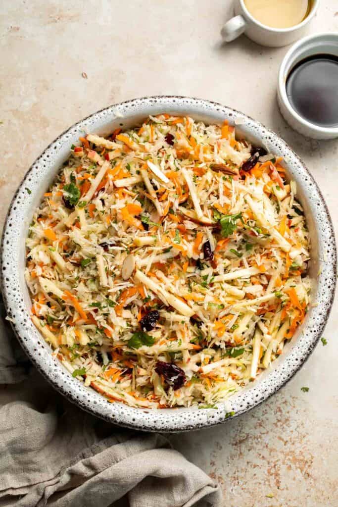 This easy apple slaw recipe is the perfect combination of crisp apples, crunchy cabbage, and a creamy dressing. A fresh side dish ready in 10 minutes! | aheadofthyme.com