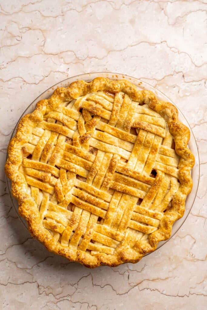 Homemade Caramel Apple Pie is warm, spiced, and gooey. A classic apple pie with caramel sauce baked inside for the ultimate fall dessert. | aheadofthyme.com