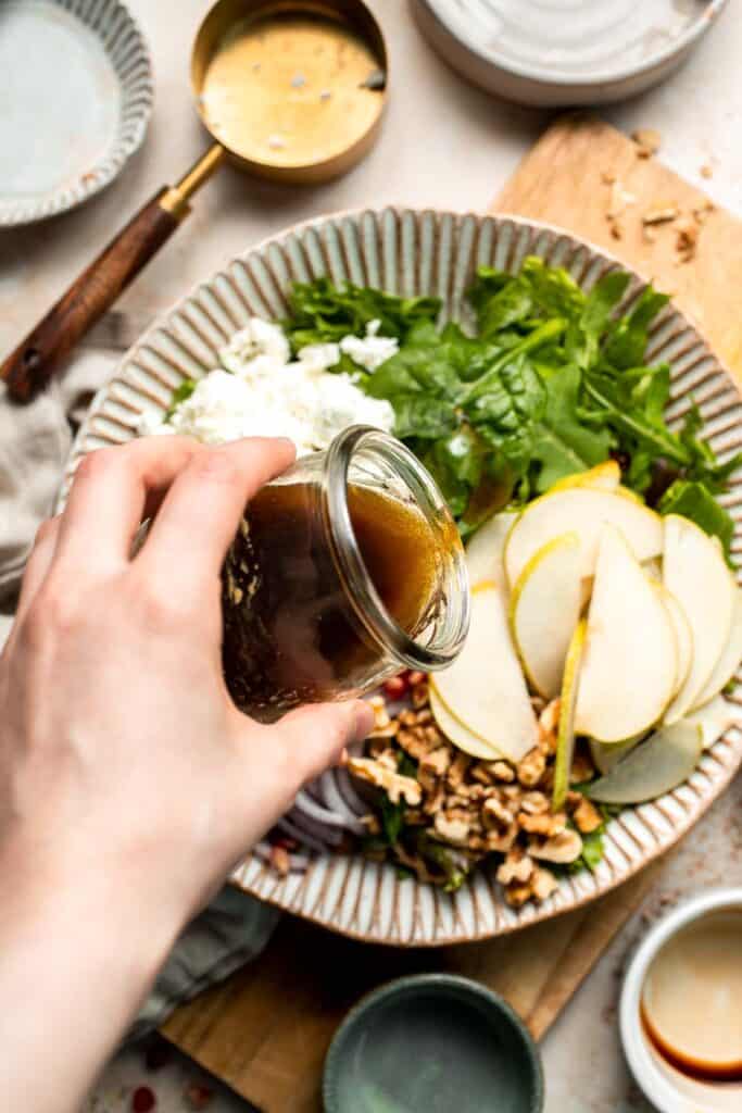 Pomegranate pear salad with walnuts, tangy cheese, and honey balsamic dressing is fresh, colorful, and perfect for holidays or everyday meals. | aheadofthyme.com