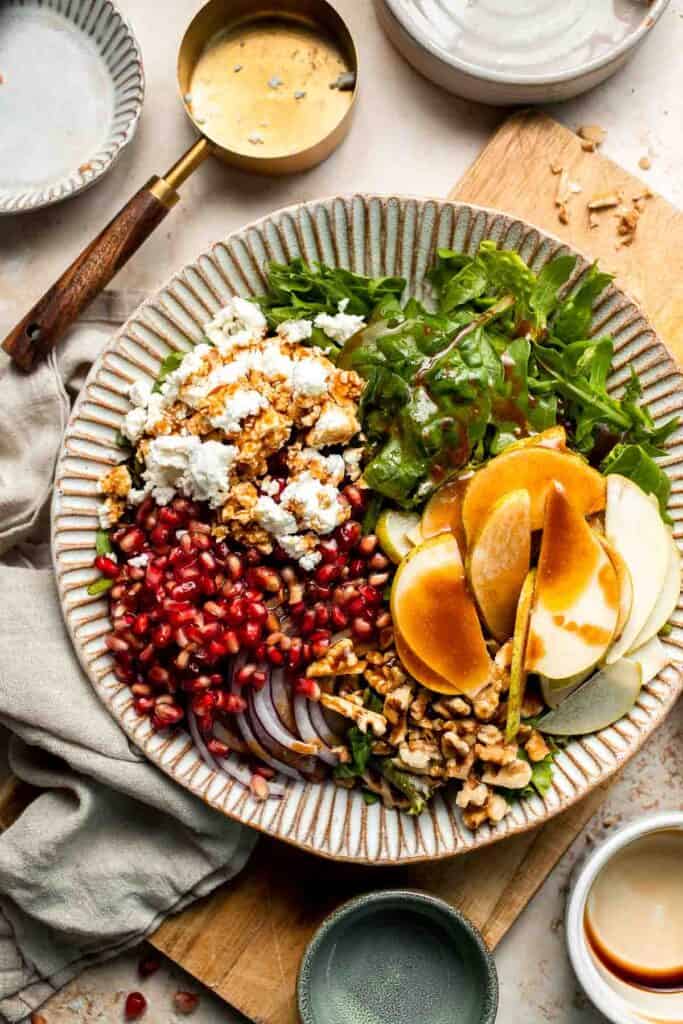 Pomegranate pear salad with walnuts, tangy cheese, and honey balsamic dressing is fresh, colorful, and perfect for holidays or everyday meals. | aheadofthyme.com