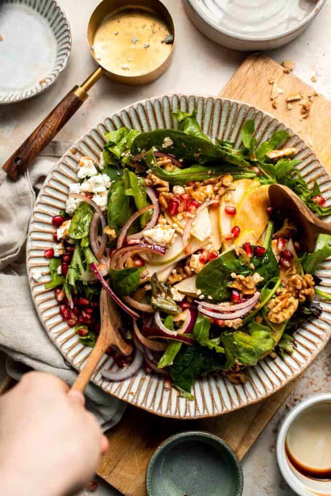 Pomegranate pear salad with walnuts, tangy cheese, and honey balsamic dressing is fresh, colorful, and perfect for holidays or everyday meals. | aheadofthyme.com
